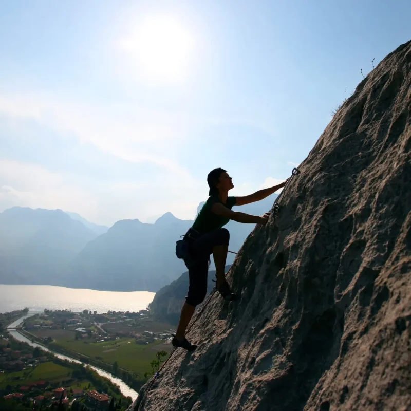 silhouette-of-female-climber-against-view-of-lake-2023-11-27-05-27-01-utc